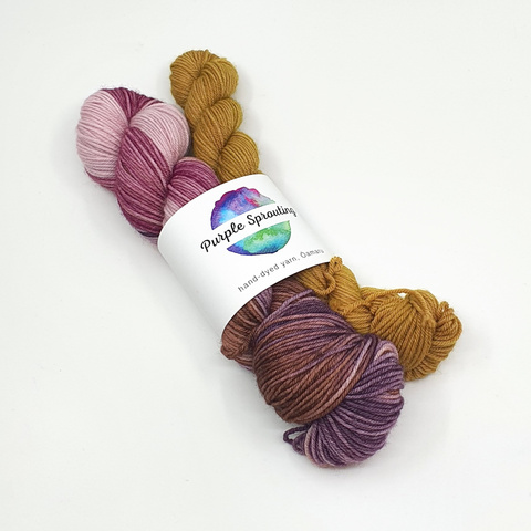 Hand-dyed yarn skeins in mustard yellow and variegated pink-purple-brown tones from Purple Sprouting, New Zealand